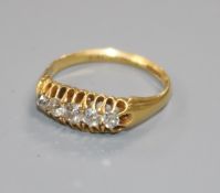 A George V 18ct gold and graduated claw set five stone diamond ring, size M/N.