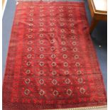 A Belouch red ground rug 187 x 117cm