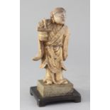 A Chinese creamy soapstone figure of He Xiangu, 19th century, holding a basket in her right hand,