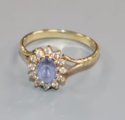 A 9ct gold, gem and diamond set oval cluster ring, size O.