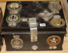 A collection of car badges mounted on a top box length 37.5cm