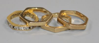 A suite of four hexagonal yellow metal bands, one set as an eternity ring with eighteen round cut