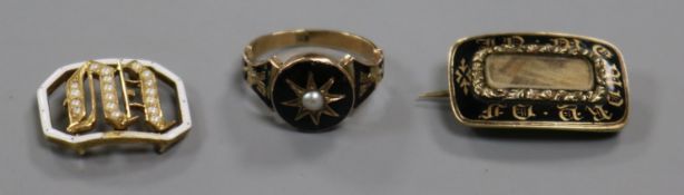 A George IV yellow metal and enamel mourning brooch, a 19th century child's? mourning ring and a