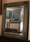 A brass mounted composition wall mirror W.55cm
