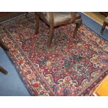 A Persian Tabriz style rug, with flowers on a red ground 214 x 150cm