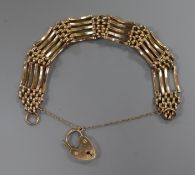 A 9ct gold gate link bracelet (a.f.) with heart shaped padlock clasp.