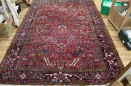 A Persian red ground rug 285 x 190cm