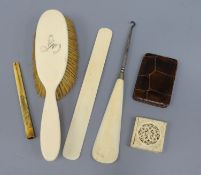 An ivory puzzle box, three other ivory items including cigarette holder and a note case