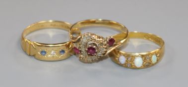 A Victorian 18ct gold, ruby and diamond openwork cluster ring and two other rings, one 18ct gold,