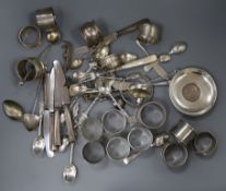 A mixed group of mainly silver and white metal items including teaspoons dish and napkin rings.