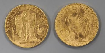 An 1897 French 'Guardian Angel' 20 franc gold coin and a similar 1906 'Rooster' coin.