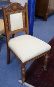 A set of eight Edwardian carved oak dining chairs