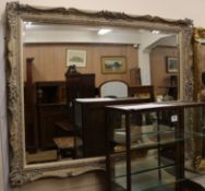 A painted composition wall mirror W.141cm H.111cm