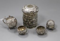 An Indian white metal jar and cover and four cruets.