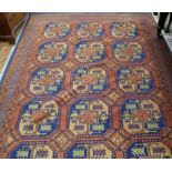 An Afghan hall carpet, field of octagons on a russet ground 288 x 199cm