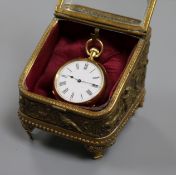 An 18ct. gold fob watch with a glazed gilt metal watch stand.