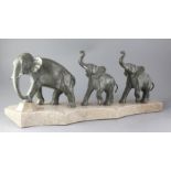 Brault. An Art Deco bronze group of elephants, a mother and two calves, mounted on a shaped marble