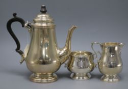 A Queen Anne style silver coffee pot with matching sugar bowl and cream jug, Sheffield 1967,