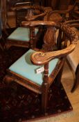 A pair of late 19th century carved oak corner chairs