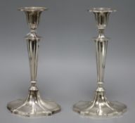 A pair of George V silver candlesticks by Walker & Hall, Sheffield, 1919, weighted, 24cm.