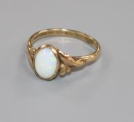 A 9ct gold and oval white opal dress ring, size N.