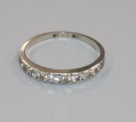 An 18ct white gold and ten stone diamond set half eternity ring, size M.