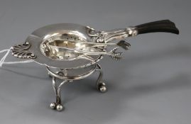 An early 20th century Danish sterling silver tea strainer, a Georg Jensen salt dish and a pair of