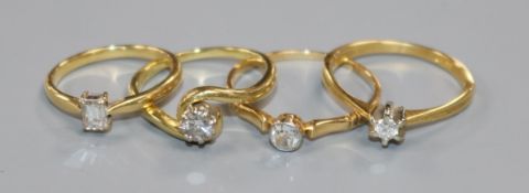 Four assorted 18ct gold and solitaire diamond rings.