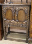 A 17th century style oak cupboard W.67cm