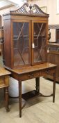 An Edwardian inlaid mahogany bookcase on associated two drawer base W.89cm