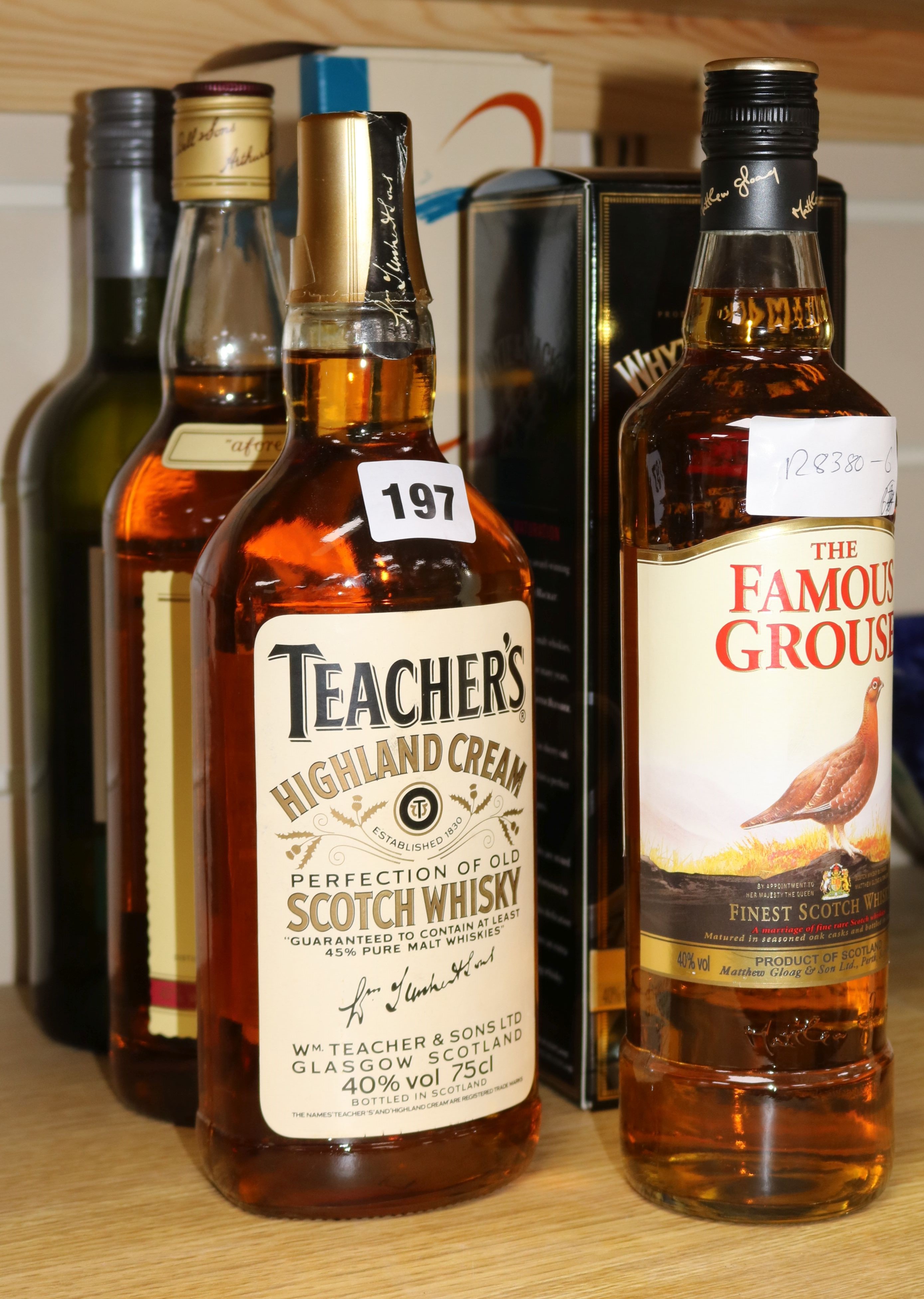 Four assorted bottles of whisky includes Bells and Teachers, a bottle of Jerez dry Sherry and bottle