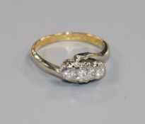 An 18ct gold, platinum and illusion set three stone diamond ring, size G.