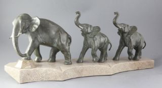 Brault. An Art Deco bronze group of elephants, a mother and two calves, mounted on a shaped marble