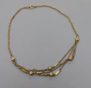 A late Victorian 9ct gold triple swag, bar and sphere necklace, 43cm.