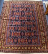 An Afghan blue ground rug 180 x 127cm