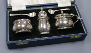 A cased 1960's Mappin & Webb three piece silver condiment set decorated with Celtic band, Sheffield,