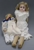 An open mouthed bisque-headed French kid bodied doll and another smaller Austrian doll