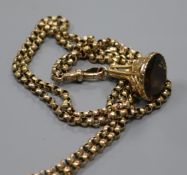 A Victorian 9ct gold guard chain hung with a yellow metal overlaid gem set fob seal, chain 150cm.