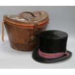 A Victorian top hat with leather case