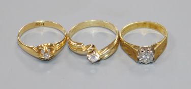 Two 18ct gold and solitaire diamond rings and a 14k and solitaire diamond ring.