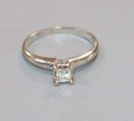 A 14ct white gold and solitaire princess cut diamond ring, size G.