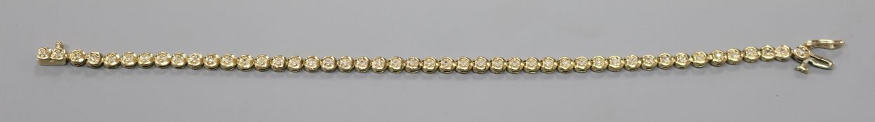 A 9ct gold and diamond set line bracelet, 19.4cm.