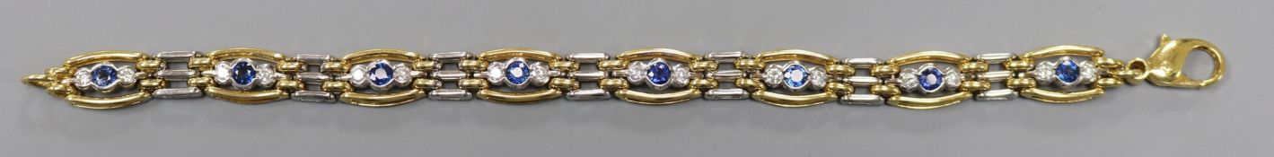 A modern 18ct two colour gold, sapphire and diamond set bracelet, approx. 19cm, gross 31.2 grams.