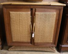 A teak and rattan side cabinet W.105cm