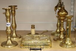 Seven brass items including candlesticks and handwarmer, etc