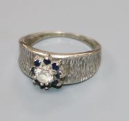 An 18ct white gold, and gem set cluster ring, size O.