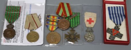 A group of assorted medals comprising an Auschwitz Cross Societe Francaise Militaires de Secours,