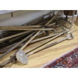 A collection of Victorian and Edwardian long handled hay forks, rakes, drain spade, etc.