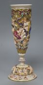 A Capo di Monte vase on stand, decorated with cherubs height 24cm