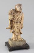 A Chinese creamy soapstone figure of He Xiangu, 19th century, holding a basket in her right hand,